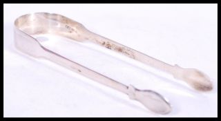 A pair of early 19th century silver hallmarked Georgian sugar tongs in the fiddle pattern being