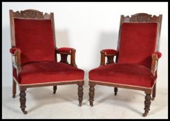 A pair of early 20th Century Edwardian button back upholstered library armchairs having red velour