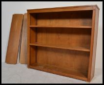 A vintage retro 20th century golden oak industrial shelving unit having fitted metal tramlines and