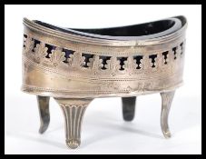 An early 19th century Georgian silver hallmarked table salt having a Bristol blue glass liner raised