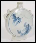 A 19th century Chinese blue and white vase of moon flask shape having hand painted details.