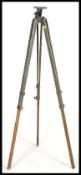A vintage retro 20th century Military tripod having folding adjustable legs with brass mounts.