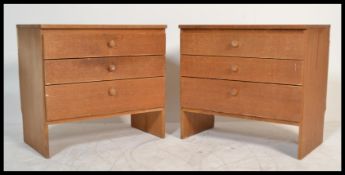 A pair of vintage retro 20th century golden oak fronted bedroom chest of drawers  having open plinth