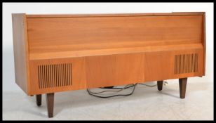 A vintage 20th Century teak wood HMV radiogram, lift up lid revealing record player and radio,aux