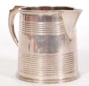 WITHDRAWN FROM SALE A 19th century Georgian silver hallmarked jug having a ribbed and beaded