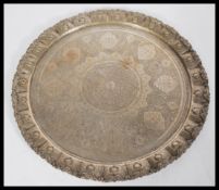 A Persian Islamic silver white metal tray, with an embossed floral design with medallions and