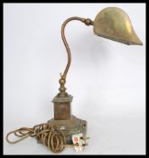 A good 20th century brass bankers desk lamp raised on a terraced square base with adjustable neck