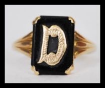 A 19th century stamped 9ct gold signet ring included the letter D with an inset black cushion cut