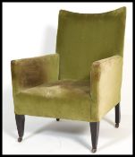 A late 19th century Victorian / Edwardian mahogany armchair having a shaped back and being raised on