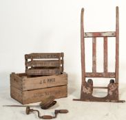 A vintage early 20th century sack barrows together with a group of vintage wooden shipping crates.