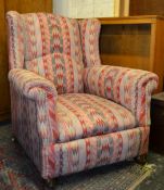 A good 19th century Victorian wing back armchair in the manner of Howard & Son. Raised on mahogany