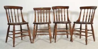 A set of four 19th century Victorian Windsor elm and beech stick back dining chairs having solid elm