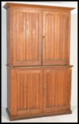 A 19th century Victorian school oak bookcase cupboard on cupboard. Both sections having twin doors