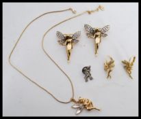 A collection of vintage jewellery featuring fairies to include a pendant necklace, a pair of drop