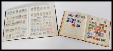 A collection of stamp albums containing stamps dating from the 19th century including penny reds.