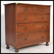 A Victorian mahogany 2 over 3 chest of drawers raised on bun feet having knob handles