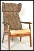 A vintage 20th Century Parker Knoll wing back open framed armchair, stamped to the frame PK 1071-74.