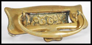 A 19th century Art Nouveau brass letter box and knocker having the word 'Letters' embossed acrossthe