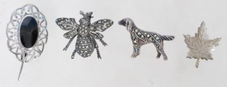 A collection of four vintage brooches to include a