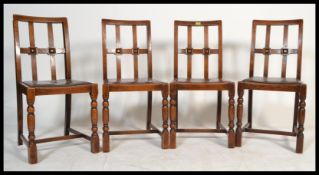 A set of four 20th Century Art Deco style dining chairs, drop in seats with a portcullis cross frame