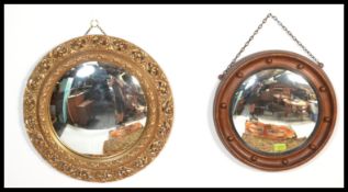 Two vintage 20th century comvex mirrors of circular form. One having a detailed ornate scrolled gilt