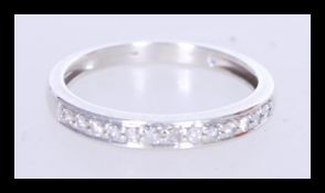 A hallmarked 9ct white gold half eternity ring set with approx 15 points of round cut diamonds.