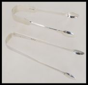 Two pairs of Georgian silver hallmarked sugar tong
