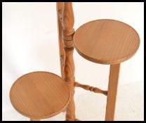 A 20th Century four tier pine plant stand / torche