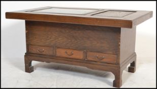 A 20th century Chinese hardwood Hibachi coffee table of low form raised on block supports with