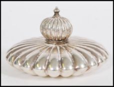 A silver hallmarked perfume bottle of flat form having a fully reeded body and lid. Hallmarked to