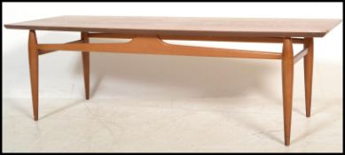A 1960's retro Danish influenced teak wood rectangular coffee occasional table, Raised on tapered