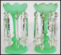 A pair of 19th century Victorian green glass lustres with with crenelated rims, having eight