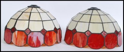 A pair of 20th Century Tiffany style stained glass ceiling / light fixture shades.