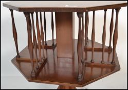 An early 20th century Edwardian mahogany revolving library bookcase of square form having boxwood