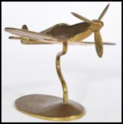 A 20th century apprentice piece brass Aeroplane jet on stand with having an articulated propeller on