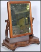 A Victorian mahogany toilet swing mirror with scrolled arms and plinth base together with a 1930's