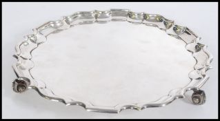 A 19th century Victorian hallmarked silver salver charger plate having a serpentine border raised on