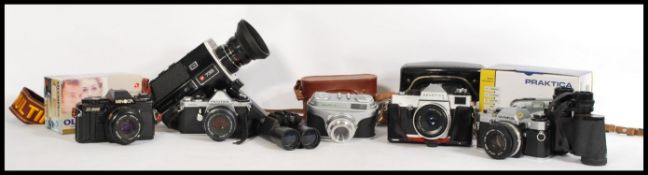 A collection of vintage 35mm cameras and lenses, to include an Olympus OM 10, Minolta x - 300,