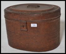 A late 19th Century tin plate hat box, hinged lid with latch to front and carry handle atop.