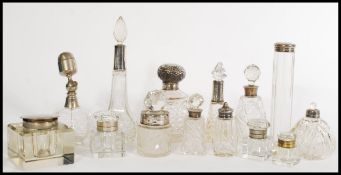 A selection of cut glass cruet and vanity items, with many having silver tops to include a