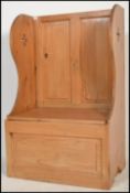 A vintage early 20th century country pine church settle hall monks bench having lift up seat with