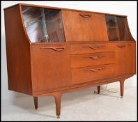 A retro 20th Century teak wood G - Plan highboard / sideboard, having an arrangement of cupboard and