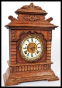A 19th century American mantel bracket clock having an oak case with gilt dial and white enamel