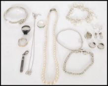A collection of silver / white metal jewellery stamped 925, to include a real pearl necklace with