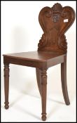 A 19th Century Victorian oak hall chair, Gothic Revival style, carved panel back, plank seat