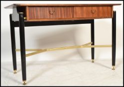 A vintage retro 20th century G-Plan Librenza pattern desk raised on tapering ebonised legs with gilt