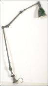 An early 20th century retro industrial work anglepoise lamp, with a pendant shade, stamped Dugdill