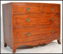 A 19th century George III 2 over 2 bow fronted bachelors chest of drawers having ebony line inlaid