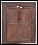 A Georgian 19th century oak country corner cabinet with twin fielded panel doors together with an