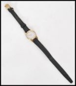 A vintage ladies Omega De Ville wristwatch having a silvered dial with gilt baton numerals and